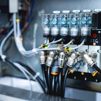 Pneumatic control board in production. Distributor of pneumatic control lines. Industrial photo.
